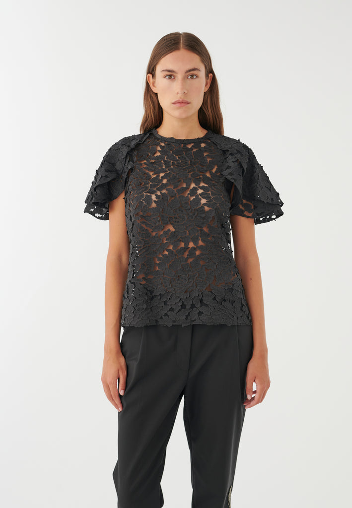 The Delilah Blouse from Dea Kudibal features layered ruffle sleeves, a round high neckline and a button up eyelet detail at the back. With a textured leaf print on a mesh base this blouse can be worn as is or with a camisole underneath.