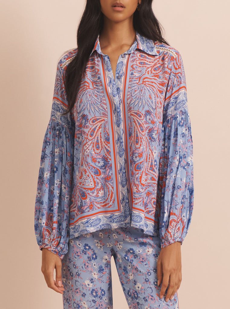 The Nora Shirt from EVARAE features opulent balloon sleeves and a button down front. in a fun multicoloured paisley print this easy to wear shirt looks fab paired with denim shorts or the matching Sandy Trousers - available in store.