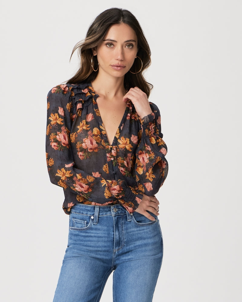 We love a Paige blouse and this one does not disappoint!&nbsp; &nbsp;Crafted from 100% silk georgette with a crinkle texture Georgiana features mini ruffle detailing at the shoulders, back and sleeves, smocked cuffs and covered buttons.&nbsp; In a pretty navy floral print this is perfect for day or evening and pairs perfectly with any shade of denim!