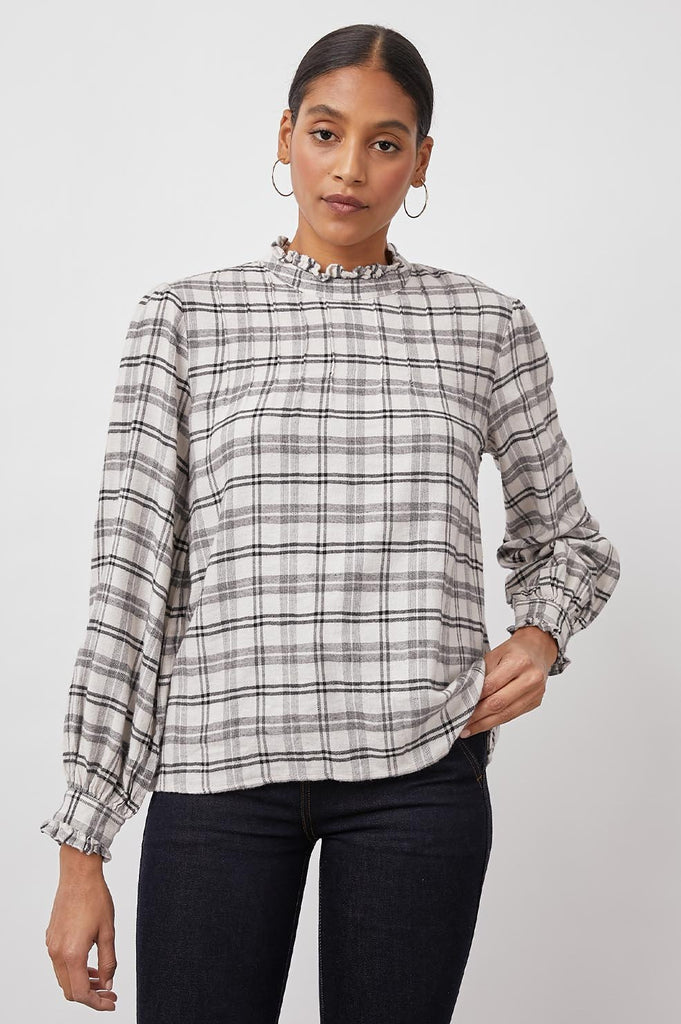 Pretty feminine blouse from our favourite Californian brand Rails.  Crafted from a super soft cotton blend in an ivory colour with a charcoal plaid design Ariana features a high neck, straight fit, ruffle details at the collar and cuff and a keyhole back with button closure.  This ladylike blouse looks great paired with your favourite denim.
