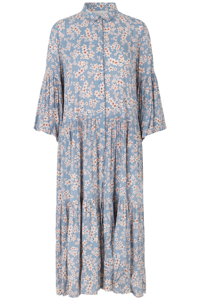 Munthe have created another gorgeous easy to wear must have dress.  Crafted from an airy, sustainable viscose in a pretty print the Fond Midi Dress features a small collar, buttons down the front, semi-short ruffle sleeves and a slightly dropped waist.  The flowy feminine drape of the skirt creates pretty lines and movement and looks perfect paired with your favourite trainers for a relaxed look or put on a pair of sandals for a slightly more elevated evening look.