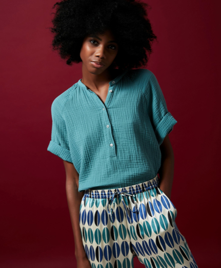 Pretty relaxed lightweight 100% cotton top from Hartford.  In a summery blue/green colour with rolled up short sleeves, half length centre buttoning and a gathered neckline this is a great running around doing chores throw on with your favourite denim or some shorts when it warms up.