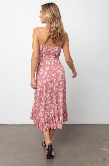 Sleeveless, V-neck, midi-length pink floral printed dress featuring thin adjustable shoulder straps, fabric covered buttons down the center front, a drawstring self-tie waistline, and a flowy bottom hem. Soft skirt lining. Feminine and flowy, this style is the perfect day-to-night dress. 