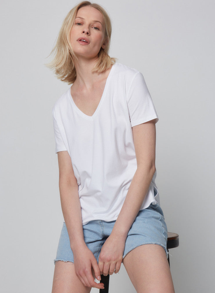 We are delighted to be stocking uber cool French basic brand Majestic Filatures.  So very soft to the touch and super comfy this boxy cut v neck is crafted from viscose and elastane and features short sleeves and side slits.  Viscose is a natural fabric that comes from a wooden fiber - the addition of elastane brings softness and movement.  Perfect oversized with denim for a casual look but also a great option for your work out wardrobe with a legging.  You'll want these in every colour!