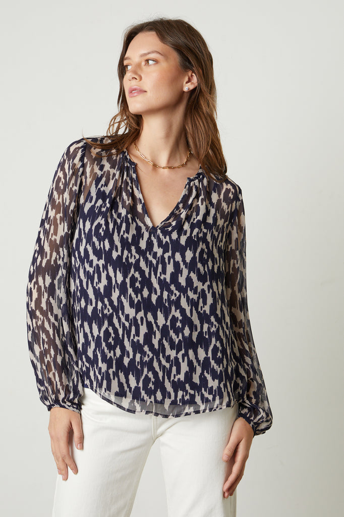 The Edna Blouse in Calico from Velvet by Graham & Spencer features a v-neckline and long sleeves with a delicate buttoned cuff. The jeans and a nice top combination never goes out of style and this is a perfect one to add to your collection. 