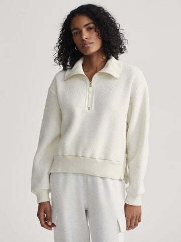 The Roselle Fleece from Varley is crafted from their 100% Recycled Plush Borg Fleece.  It is a loose fit and features a half-zip collar, ribbed cuffs and hem, and zip detailing on the sides. The top will sit perfectly over any of the Varley pants or leggings and will be a welcome upgrade to your lounge/ travel/ gym wear.