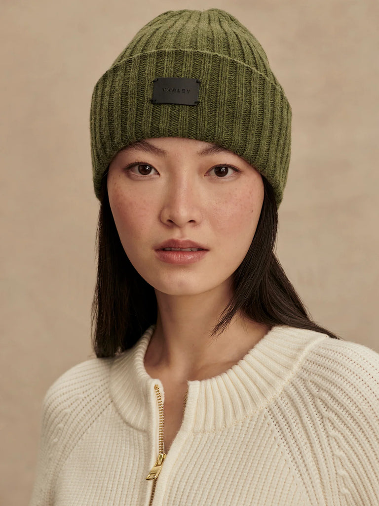 Keep cosy during the colder seasons with the Elva Beanie from Varley. Crafted from a soft merino wool blend, this beanie features a chunky rib texture, a fold-over deep cuff and the Varley logo.