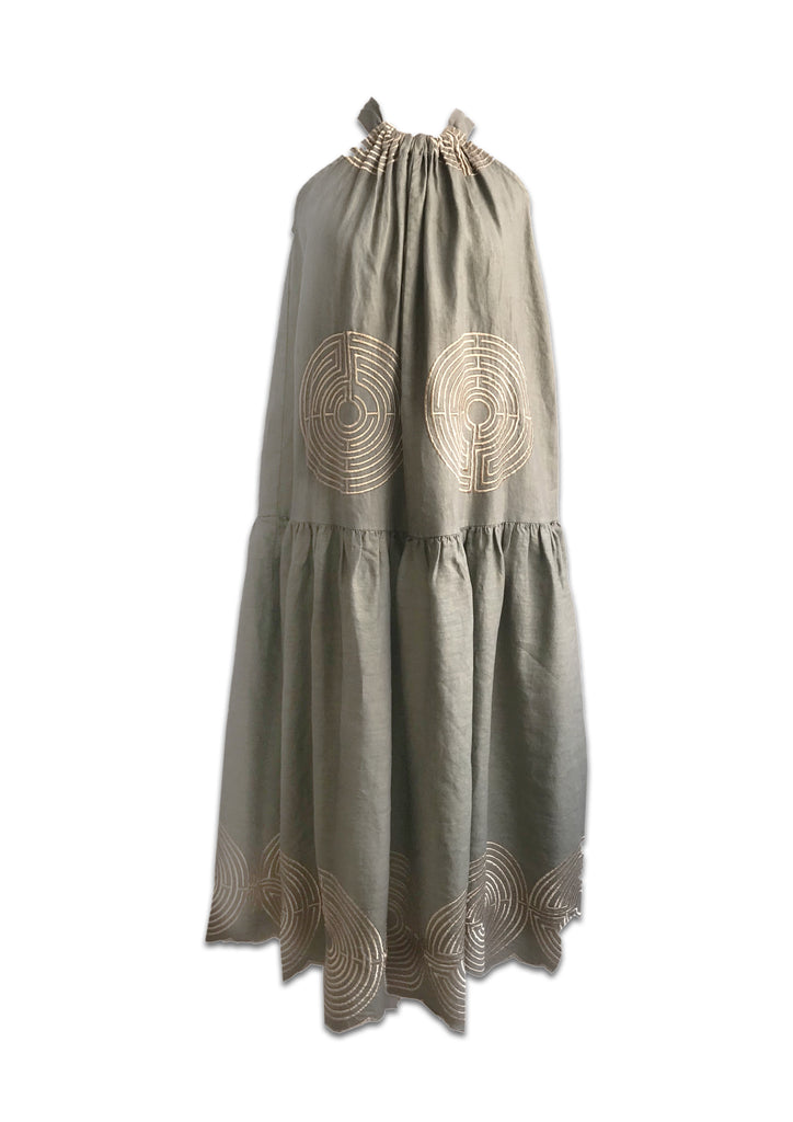 This gorgeous embroidered dress by Greek Archaic Kori is a perfect combination of classic Greek style and modern sophistication. It is crafted from 100% linen and comes in this beautiful tea green paired with stunning gold embroidery.  It features a halter neckline with a pretty bow tie at the back.         