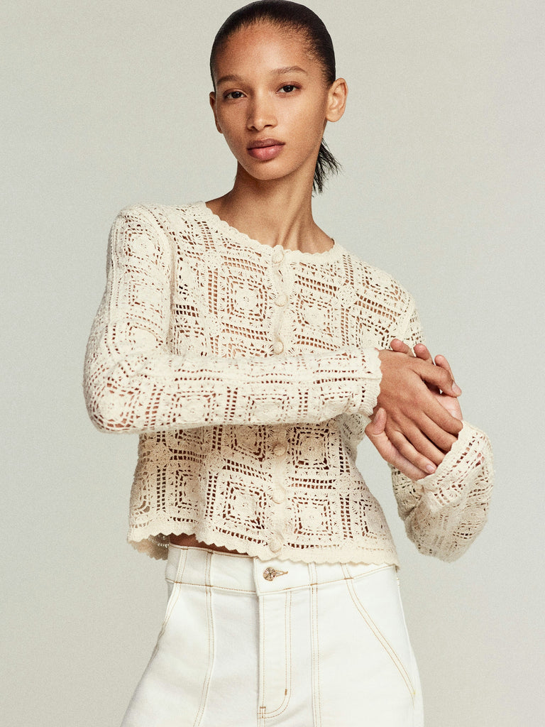 Talk about an elevated humble cardigan!&nbsp; This gorgeous little cardi from uber cool brand Frame is crafted from pure cotton and features a geometric open knit pattern throughout and scalloped edging.&nbsp; For an added bit of luxury this has been finished with fabric covered buttons.&nbsp; Charming and feminine this is perfect paired with your favourite denim.
