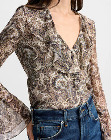 Effortlessly beautiful and super feminine the Kyrie Silk Blouse from Veronica Beard is crafted from 100% silk and comes in an all over subtle paisley print.&nbsp; This beautiful airy bias-cut blouse features flirty sheer bell sleeves and a ruffled v neckline.&nbsp; Floral shell buttons add a polished finish.&nbsp; Pair with your favourite denim for a cool boho girl chic look.&nbsp;