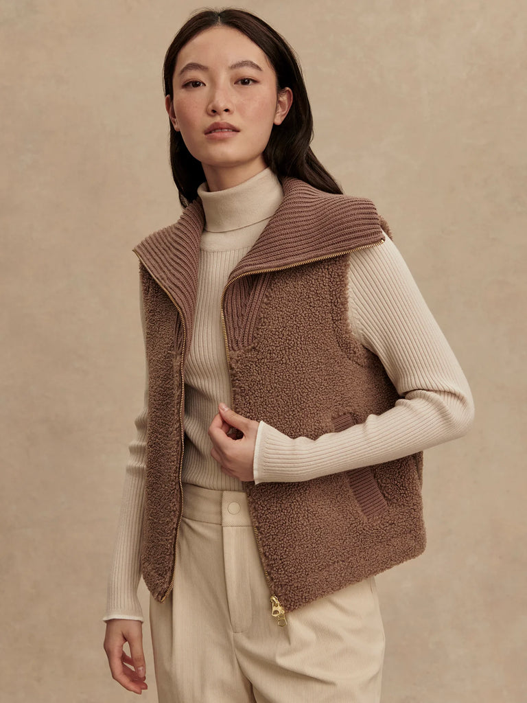 Cosy up in this lovely soft boucle sherpa gilet and a "goes with anything" neutral ash taupe colour.&nbsp; Cut to a flattering loose fit which will layer over your favourite tops or under one of the new Kirsten or Alyssa raincoats for the extra layer of warmth.&nbsp; A knitted zip up funnel neck will keep you toasty and warm and there is also a knitted detail on essential side pockets.