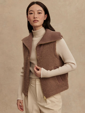 Cosy up in this lovely soft boucle sherpa gilet and a "goes with anything" neutral ash taupe colour.&nbsp; Cut to a flattering loose fit which will layer over your favourite tops or under one of the new Kirsten or Alyssa raincoats for the extra layer of warmth.&nbsp; A knitted zip up funnel neck will keep you toasty and warm and there is also a knitted detail on essential side pockets.