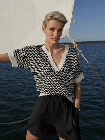 The Dora knit top from Varley has a relaxed fit with a drop shoulder and deep V-neckline that takes inspiration from a classic Polo collar. Made from 100% cotton with a textured two-colour stitch.


