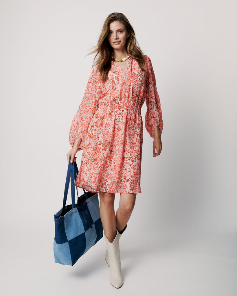 Easy throw on and go dress from uber cool Scandi brand Moliin!&nbsp; Featuring a flattering v neck with self ties, elastic at the waist and long voluminous sleeves this dress is flowy and feminine.&nbsp; This knee length dress is great paired with a trainer for an elevated day look or a pretty sandal for evening drinks.