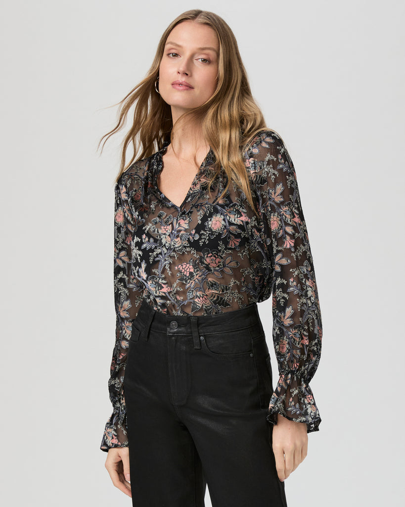 We love a Paige blouse and this one does not disappoint!   Crafted from black satin with a floral burnout design this is fabulously feminine and flirty!  Featuring a v-neckline, elastic ruffle cuffs and a slight puff shoulder look cunningly chic by pairing this with your favourite wide leg black trousers or denim.   