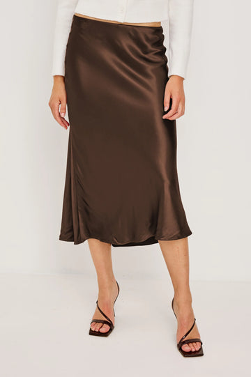 Anya is a super silky satin crepe midi skirt, featuring a concealed elasticated waistband and an extremely flattering bias cut.&nbsp; In a rich luxurious looking chocolate this looks fab paired with a bit chunky knit or dress it up with a little silky top for an evening look!