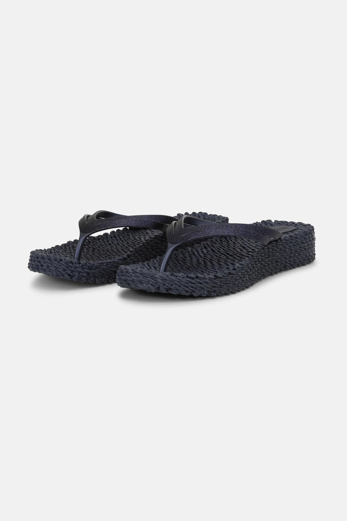 Slip on these super comfy platform flip flops by Ilse Jacobsen which will take you from beach days to nights out. The indigo and glitter finish adds a touch of glamour and the textured sole not only gently massages your feet but is made from Air Rubber keeping the shoe lightweight and flexible.  Other styles and colours available in store.


