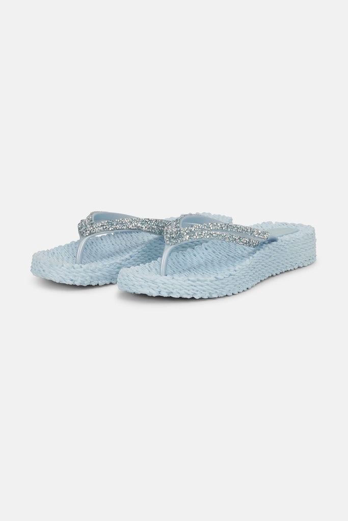 Slip on these super comfy platform flip flops by Ilse Jacobsen which will take you from beach days to nights out. The pale blue and rhinestone finish adds a touch of glamour and the textured sole not only gently massages your feet but is made from Air Rubber keeping the shoe lightweight and flexible. Other styles and colours available in store.


