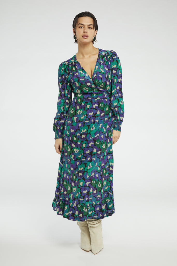 The Natalia Dress from Fabienne Chapot features a v-neckline, light balloon sleeves and smocked cuffs. This versatile wrap dress ties at the side and is in a fun green and purple floral print. Perfect with boots and/or sandals - this dress can easily be dressed up or down.