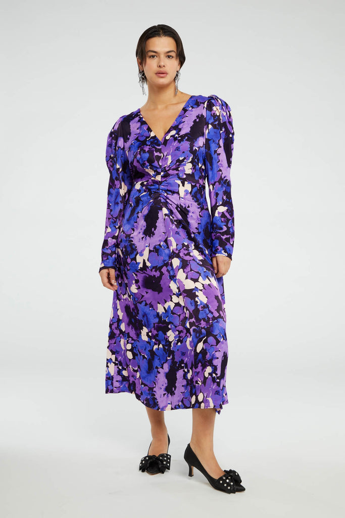The Vera Dress from Fabienne Chapot features a v-neckline, ruching at the waist and slim long sleeves with button details. This pretty maxi dress in a blue and purple floral print will look fab with strappy heels - great for an occasion!