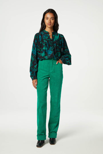 The Resa Blouse from Fabienne Chapot features fabric covered buttons down the front and long cuffed sleeves. In a green and turquoise floral print, this blouse looks fab paired with your favourite denim.