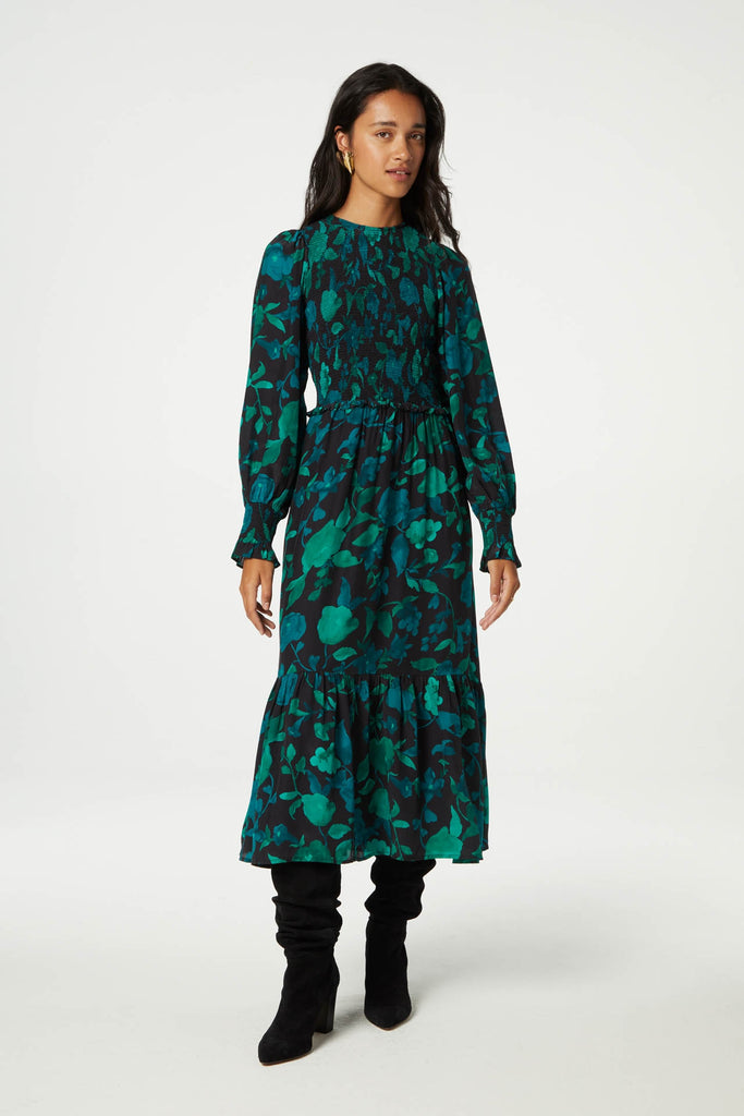 The Caro Dress from Fabienne Chapot features a smocked bust, a crew neckline and long sleeves with elasticated cuffs. This maxi dress can be dressed up or down with boots or heels.