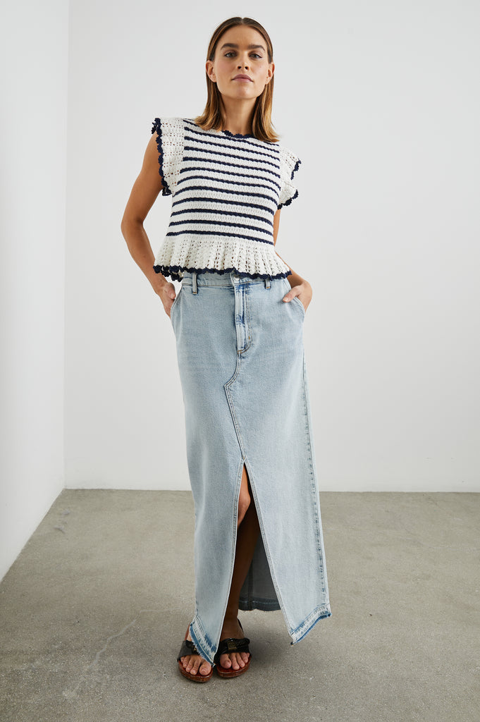 Trust me you will want a crochet top this season!&nbsp; The Coen knit from Rails is a perfect choice.&nbsp; In a lovely navy and cream and featuring a crew neck, ruffle detail at the sleeve and hem and on trend striping this is perfect paired with your favourite denim jeans or skirts.
