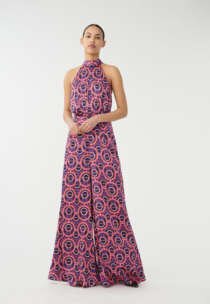 The Clea Jumpsuit from Dea Kudibal is crafted from silk in a fun pink and purple print. Unlock your 70s style with the wide leg, fitted waistband and halter-neckline. Wear with heels and a leather jacket and you are set for the coming party season.
