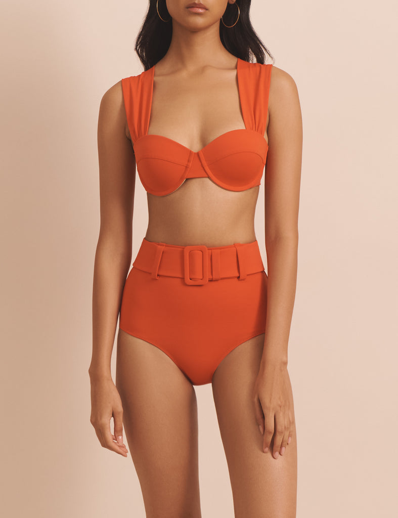 The Audrey Bikini Top from EVARAE features a flattering neckline, built-in cups with underwire and a bow tie up detail at the back. This bikini top is a must have for your next getaway with the matching Elena Flame Bikini Bottoms.