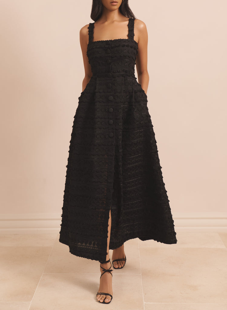 The Arla Dress from EVARAE is a fully lined midi dress crafted from 100% BCI cotton. Featuring a fringed texture, button front detailing and a square neckline this stunning black dress is one for a special occasion.