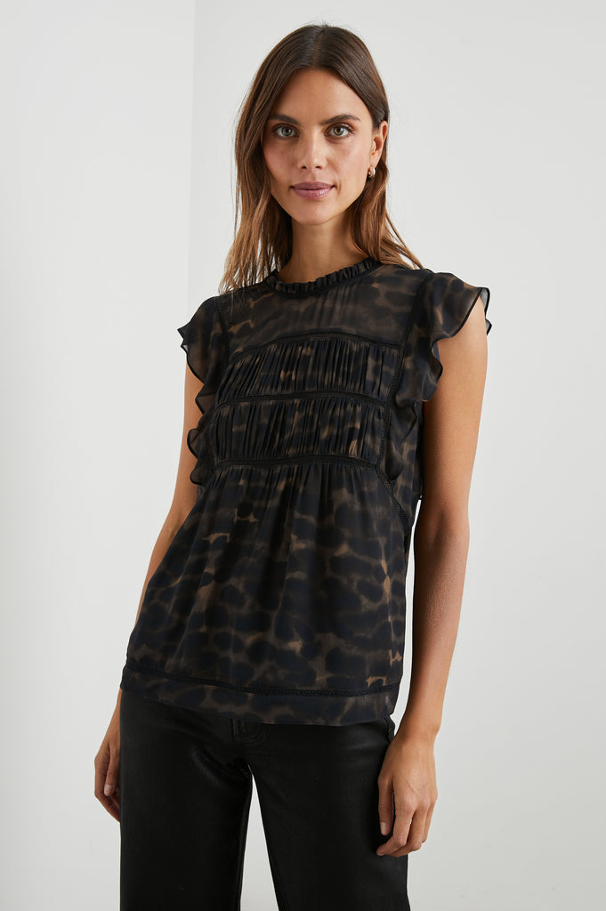 The Filomena Top from Rails offers a feminine but cool look with the contrast of the frills and leopard print. With voluminous flutter sleeves, pleating across the bust and intricate mesh details at the front and back - this 100% cotton top is suitable for both work and play.
