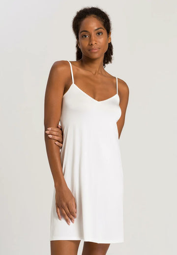 A slip is an essential item in every women's wardrobe! The Satin Deluxe Bodydress from Hanro is perfect. Crafted from super soft flowing viscose and a bit of elastane for stretch and featuring a gentle v neck this is just what you need under your clingier dresses and slips or wear it at home to lounge in.