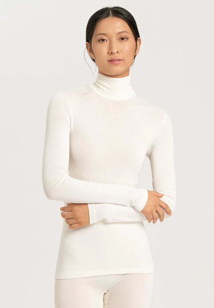 This new long sleeved turtle neck top from Hanro's woollen silk range is crafted from soft merino wool and silk. It features seamless sides and a satin trim and is perfect for layering. Fitted without being clingy this will quickly become one of your favourite tops. 