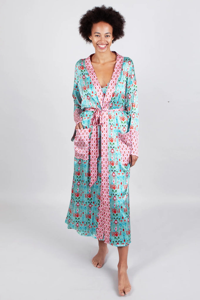 The silk Iko Long Robe is luxuriously soft and features Jessica Russell Flint's teal hand-painted IKAT Western inspired print.  It has a generous cuff and belt in a contrasting print, matching the pockets and trim.  Pair with the Iko Short Pyjamas.