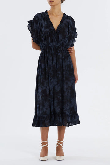 The Idina midi Dress from Lollys Laundry comes in a washed black print and has a    v-neckline with crossover front detail and short sleeves.  It features frills at the neckline, sleeves and hem, giving a feminine look to the design.  It can be dressed up or down for different occasions, just add your favourite sandals or trainers!