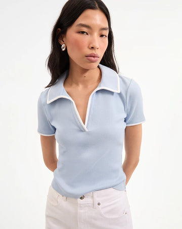 The feminine Kearney Tee is crafted from a super soft stretchy cotton blend in a pretty pale blue and features white contrast piping along the collar and sleeves, a buttonless placket for a sleek finish and a neat fit.&nbsp; This is a top you'll reach for again and again - perfect with white trousers for an elevated look but equally lovely with comfy denim shorts.