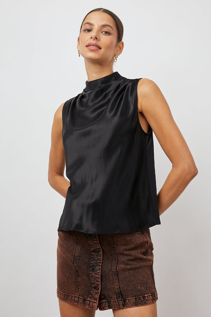 Kaleen definitely deserves a place in your wardrobe.  This will quickly become one you reach for again and again.  A sleeveless mock neck is a timeless silhouette and the draping around the chest makes is very flattering and in always wearable black - we love it. 