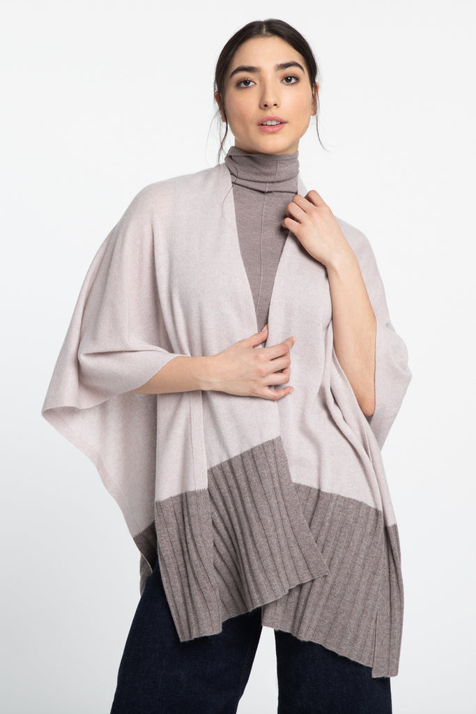 This gorgeous 100% cashmere textured travel wrap is the epitome of quiet luxury.  In gorgeous muted taupe and beige and with part ribbing and part smooth textures no matter what class you're flying in when you're wrapped up in this it will feel like like first class!