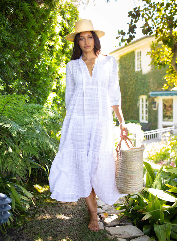 How beautiful is this dress? The perfect coverup. Sheer, window pane textured cotton in a summery white. The maxi length and mid length sleeves ensure this dress is the perfect versatile holiday piece, just add one of our beach bags and flip-flops and you're ready! 