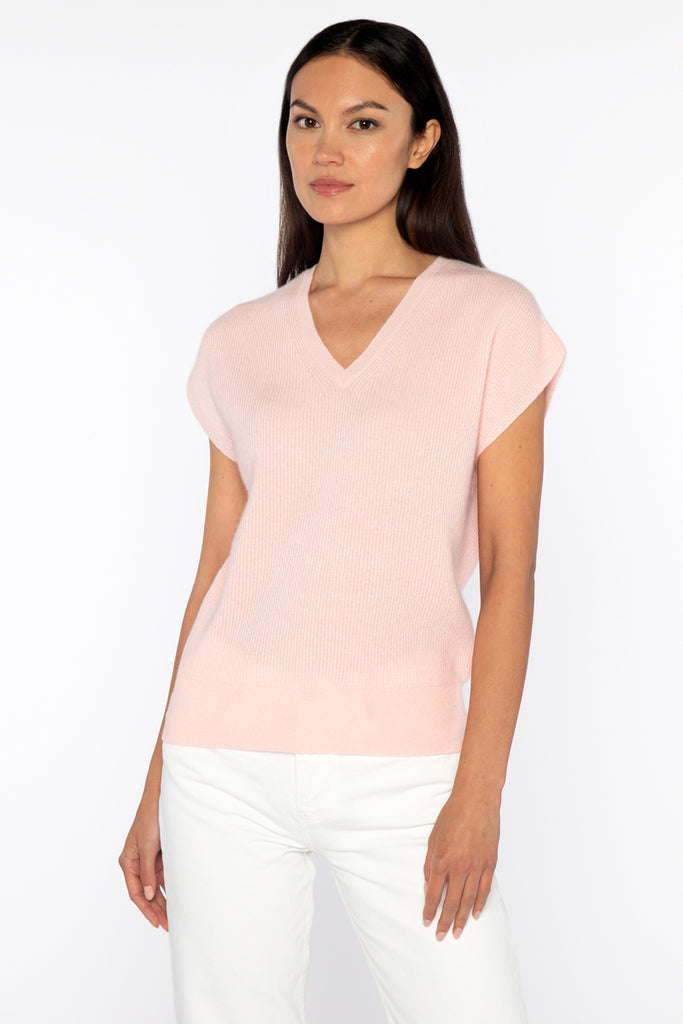 This cap sleeve cashmere top from Kinross is hugely versatile and ever so pretty and soft.&nbsp; In a delicate blush colour with the perfect vee this is just as lovely on it's own as it is worn over a long sleeved white tee or a crisp white shirt.&nbsp; Available in Celadon in store.