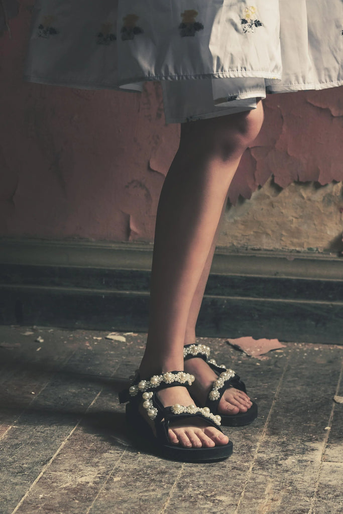 The Trekky sandal are known for their incredible comfort and their play on the “ugly shoe” look.  They are made with recycled bottles, are adorned with faux pearls have adjustable velcro straps.  These are sure to add a fun and unique element to any outfit and will no doubt become a staple in your summer/ holiday wardrobe.  