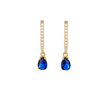 We are excited to be stocking Greek Jewellery brand Marianna Lemos!   The Elegant Pear Drop Earrings are crafted from 22 carat gold plated Sterling silver and feature a dark blue pear drop crystal suspended from an oval hoop set with white crystals.  They would be perfect with your party wear!