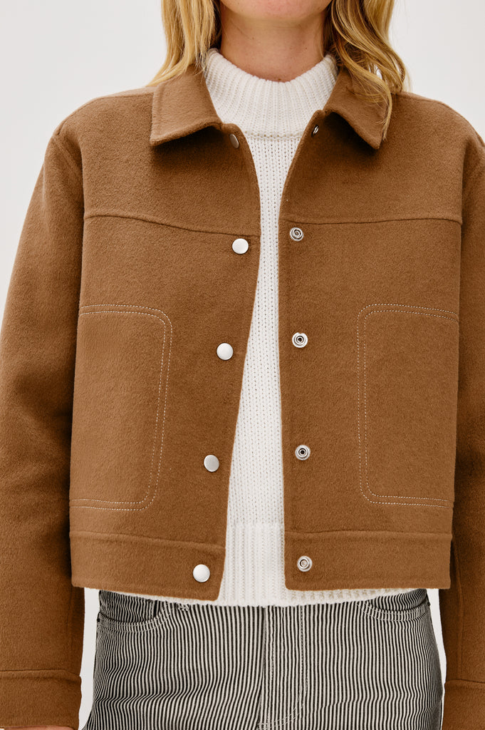 This is a pretty jacket style from our favourite Californian lifestyle brand Rails.&nbsp; The Mountain Jacket in always wearable camel features a shirt type collar, central snap closure and 2 side pockets.&nbsp; With a neat short shape this is perfect paired with all your wide legged denim.&nbsp; A great extra layer as the temperatures get a bit chillier.