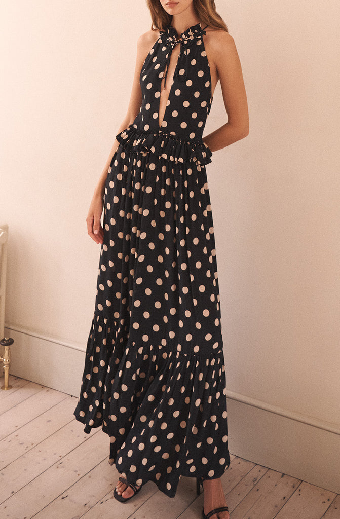 The Alegra Dress from EVARAE features a dropped waist with frill detail, a plunging neckline and drawstring ties at the neck that can be worn open or closed. This maxi dress is perfect for those warm summer evenings with a cocktail in hand.