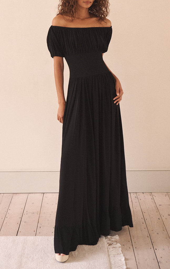 The Hestia Dress from EVARAE is an elegant off-the-shoulder piece that features slight ruched sleeves, a flattering bodice and a smocked back for extra ease and comfort. Effortlessly wear on those warm summer evenings with a cocktail in hand.