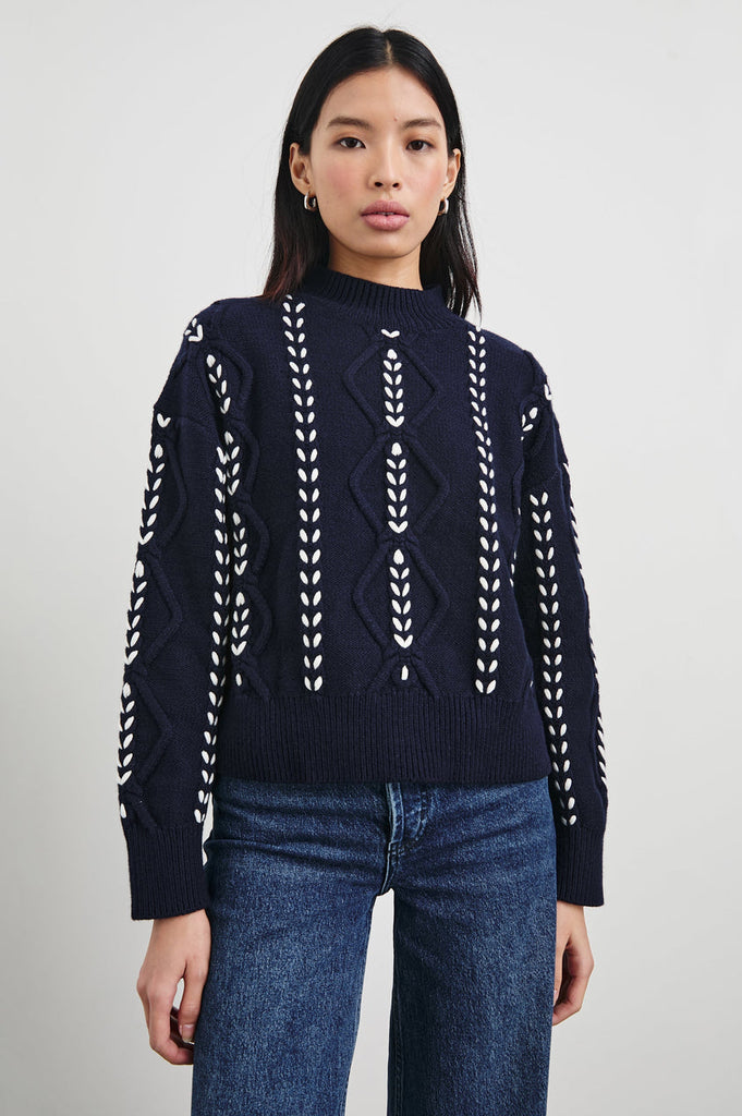 Say hello to Tori!  She is an elevated take on the traditional cable jumper!  Crafted from a heavy wool blend with a pretty white contrast stitch, ribbing at the mock neck and a boxy fit.  The is perfect with your wide legged denim. 