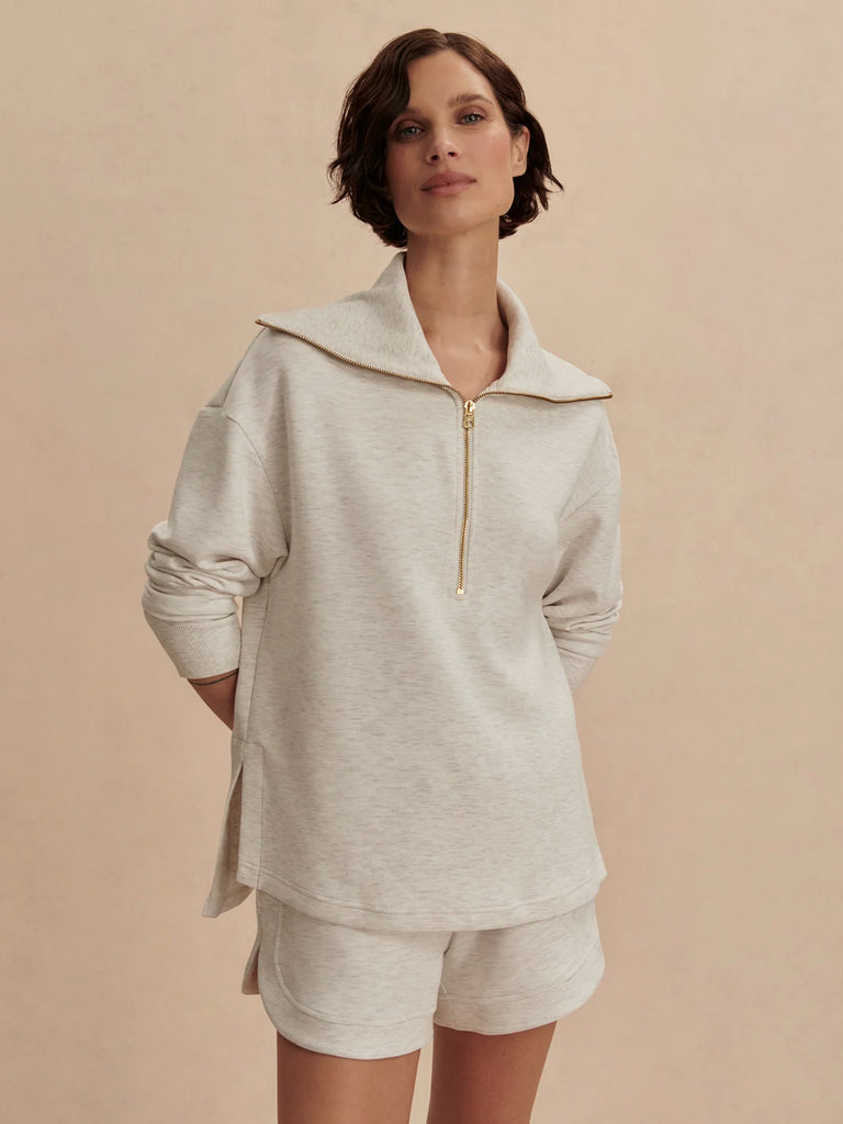 We love Varley's double soft fabric and this new Larson half zip does not disappoint. Coming in a universal ivory marl, it pairs well with the matching joggers. With a wide collar and side slits, the top will sit perfectly over leggings and will be a welcome upgrade to your lounge/ travel/ gym wear.