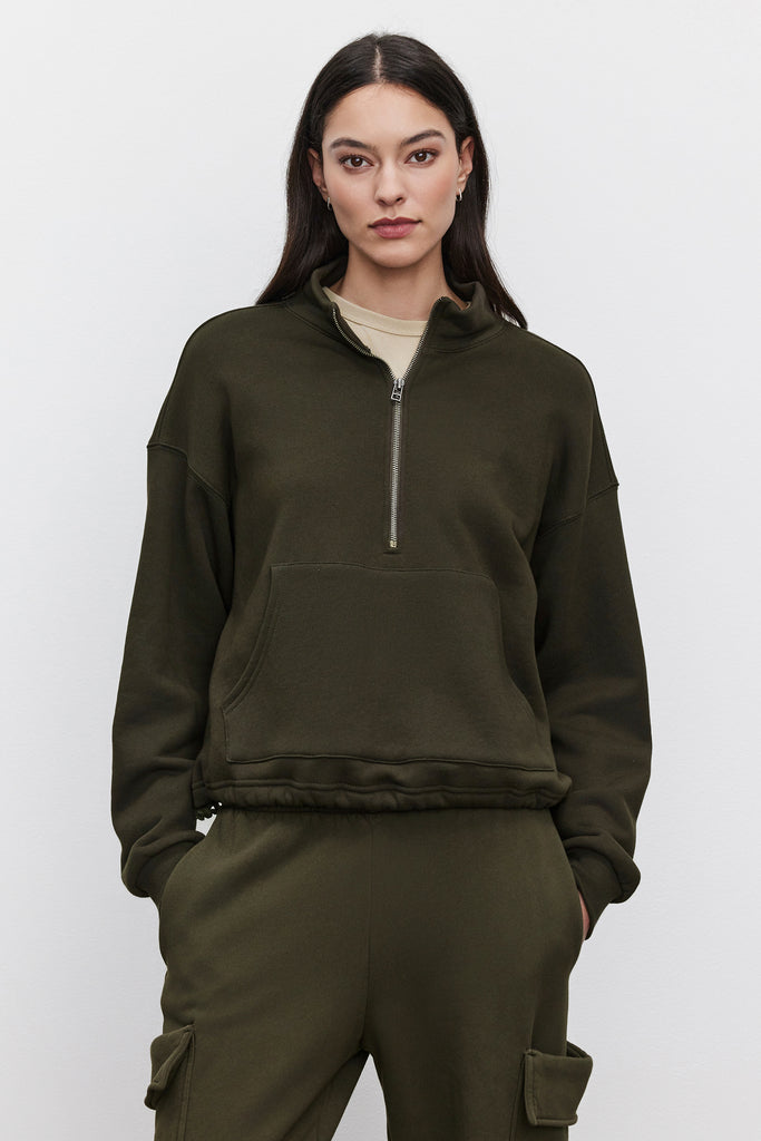 This super comfy sweatshirt is crafted from a cozy fleece fabric and features a quarter zip,&nbsp; drop shoulder seams, central large patch pocket and elastic at the waist.&nbsp; In a gorgeous dark green this is the perfect weekend essential!