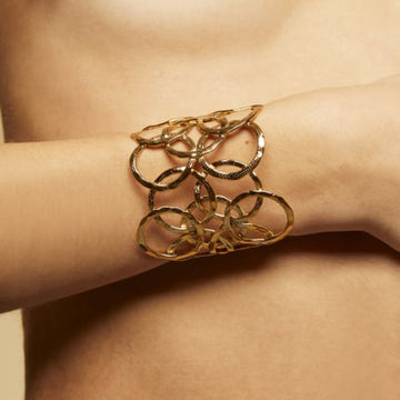 This beautiful cuff from our favourite French jewellery brand Gas Bijoux is 24 karat gold plated and just beautiful! Composed of overlapping circles which have been finely hand hammered it is adjustable thus making it a perfect gift!&nbsp; A real statement bracelet!