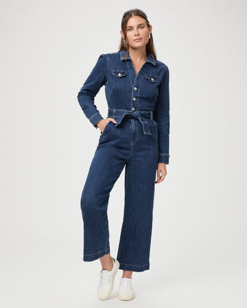 This stunning Anessa Jumpsuit is back with long sleeves in a great dark denim.  Perfect for Autumn/Winter! Featuring a cropped wide leg, a button front v-neckline and a quilted tie-up waist detail, this jumpsuit creates a flattering silhouette and a super long leg look and is one you'll reach for again and again. 
